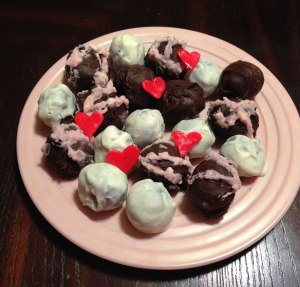 Chocolate Truffles dipped in Milk Chocolate and White Chocolate. I colored the white chocolate pink with strawberry juice to decorate the top, and made taffy hearts. Cute?